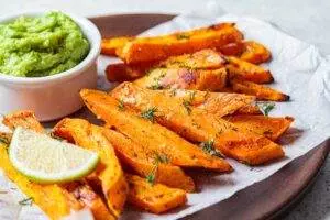 Sweet potato fries with guacamole and lime.