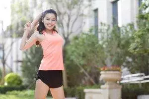 Happy young Chinese woman exercising in the morning