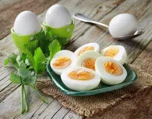 Boiled eggs on rustic wooden table.