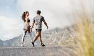 Couple walking together in fitness attire outdoors
