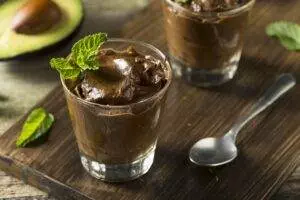 Homemade avocado chocolate pudding served with mint garnish.