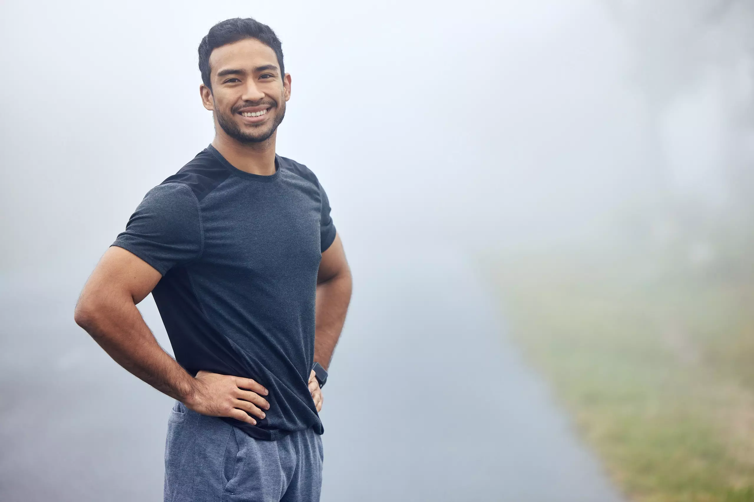 Healthy Man smiling during foggy outdoor workout.