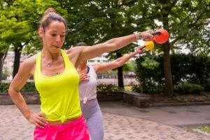 Woman performing kettlebell workout in park