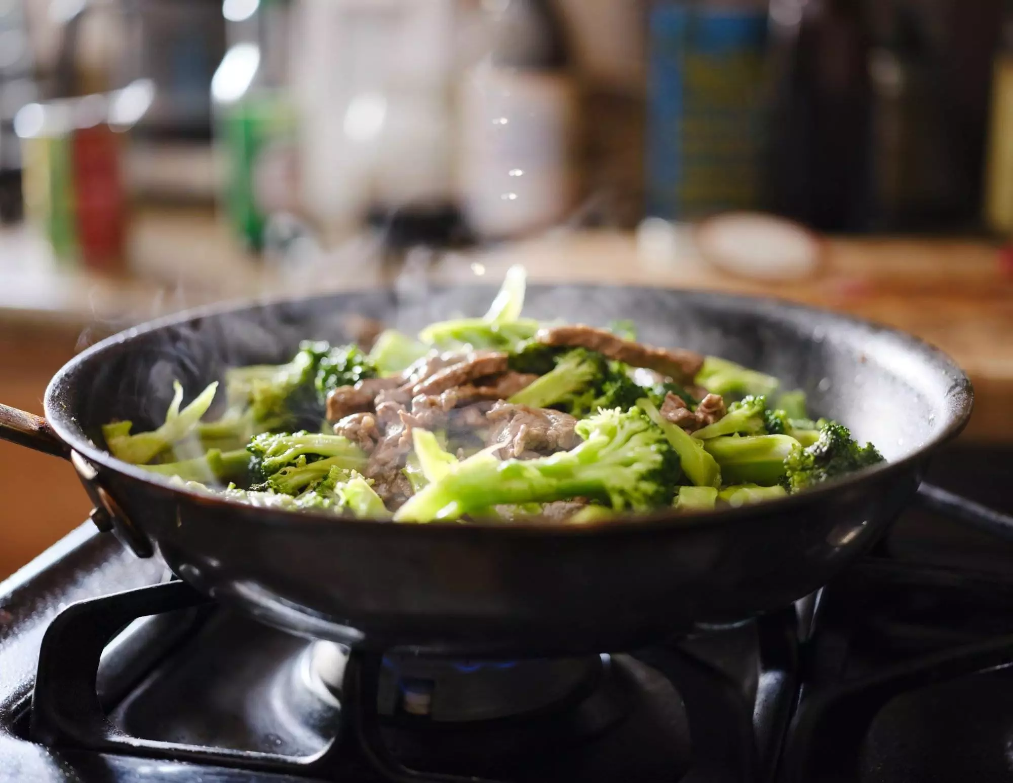 Stir-fried beef and broccoli in skillet.