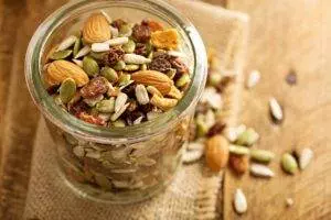 Mixed nuts and seeds in glass jar.