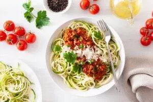 Zucchini noodles with tomato sauce and parmesan cheese.
