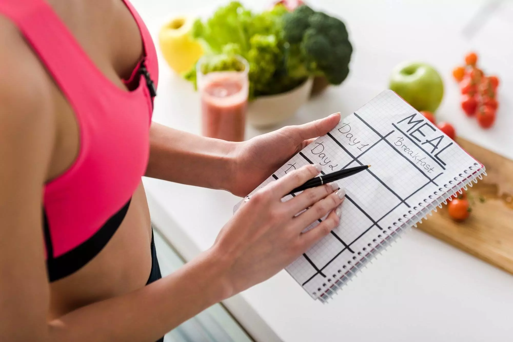 Woman planning meal schedule for healthy eating.