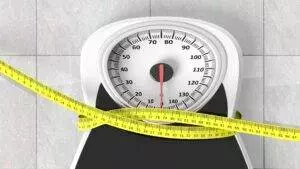 Bathroom scale with measuring tape.
