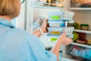 Organized meal prep containers in refrigerator.