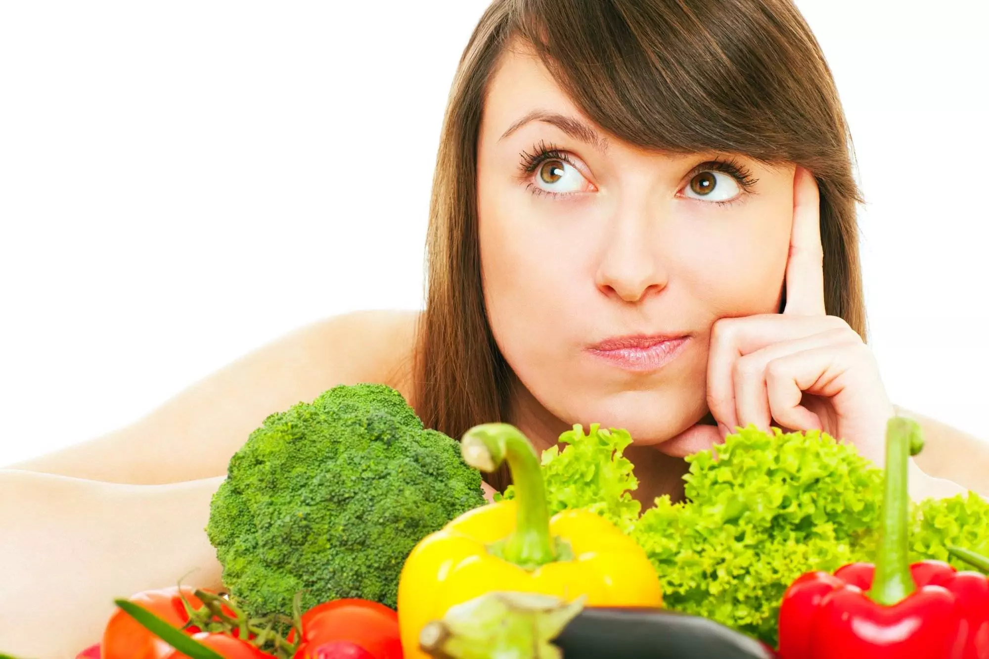 A picture of a young woman posing with vegetables over white background