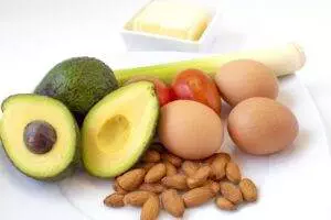 Healthy food ingredients including avocado, eggs, almonds, and tomatoes.