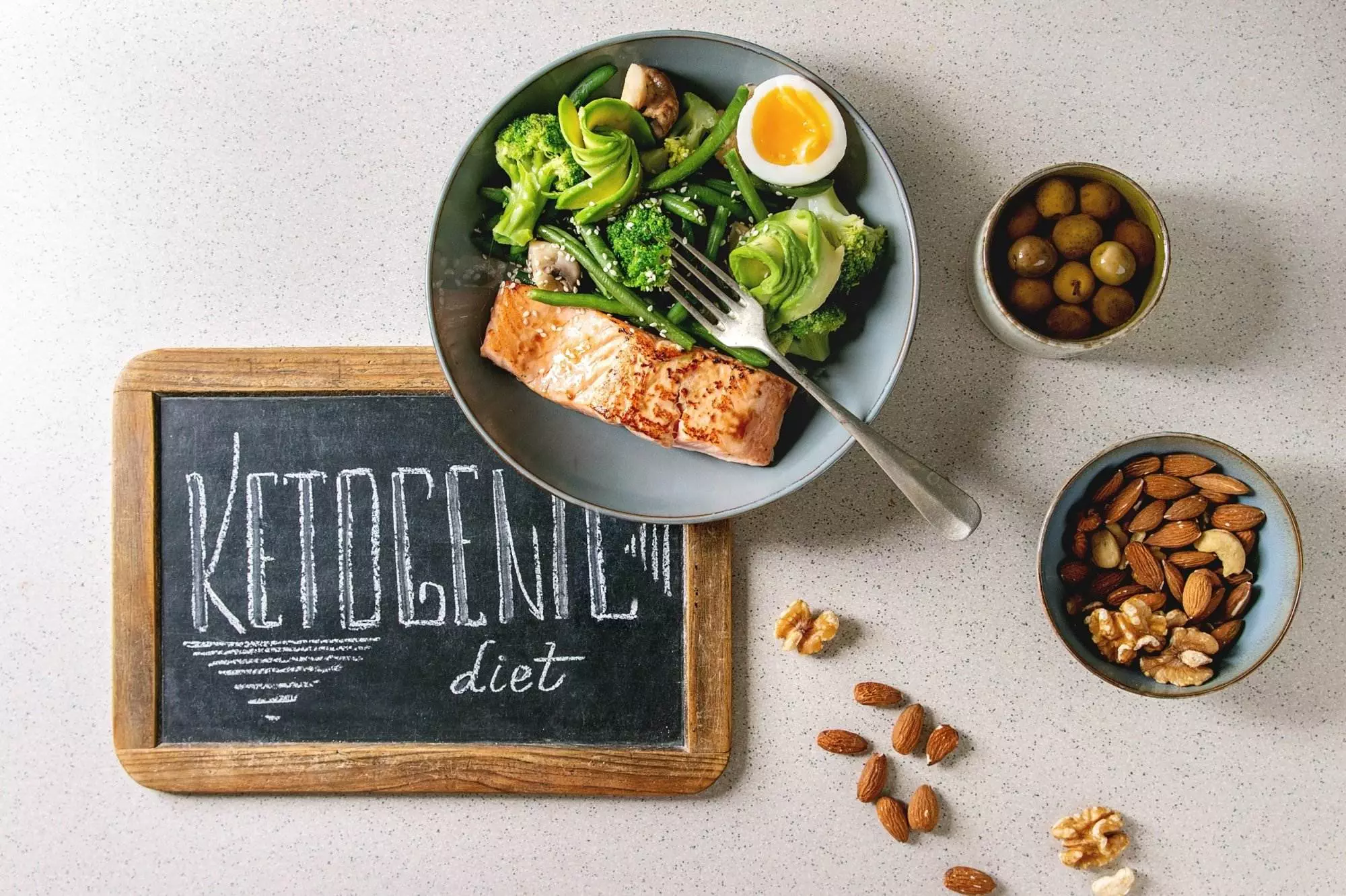 Ketogenic diet meal with salmon, vegetables, eggs, nuts.