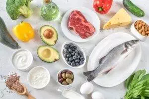 Variety of healthy foods on white surface.