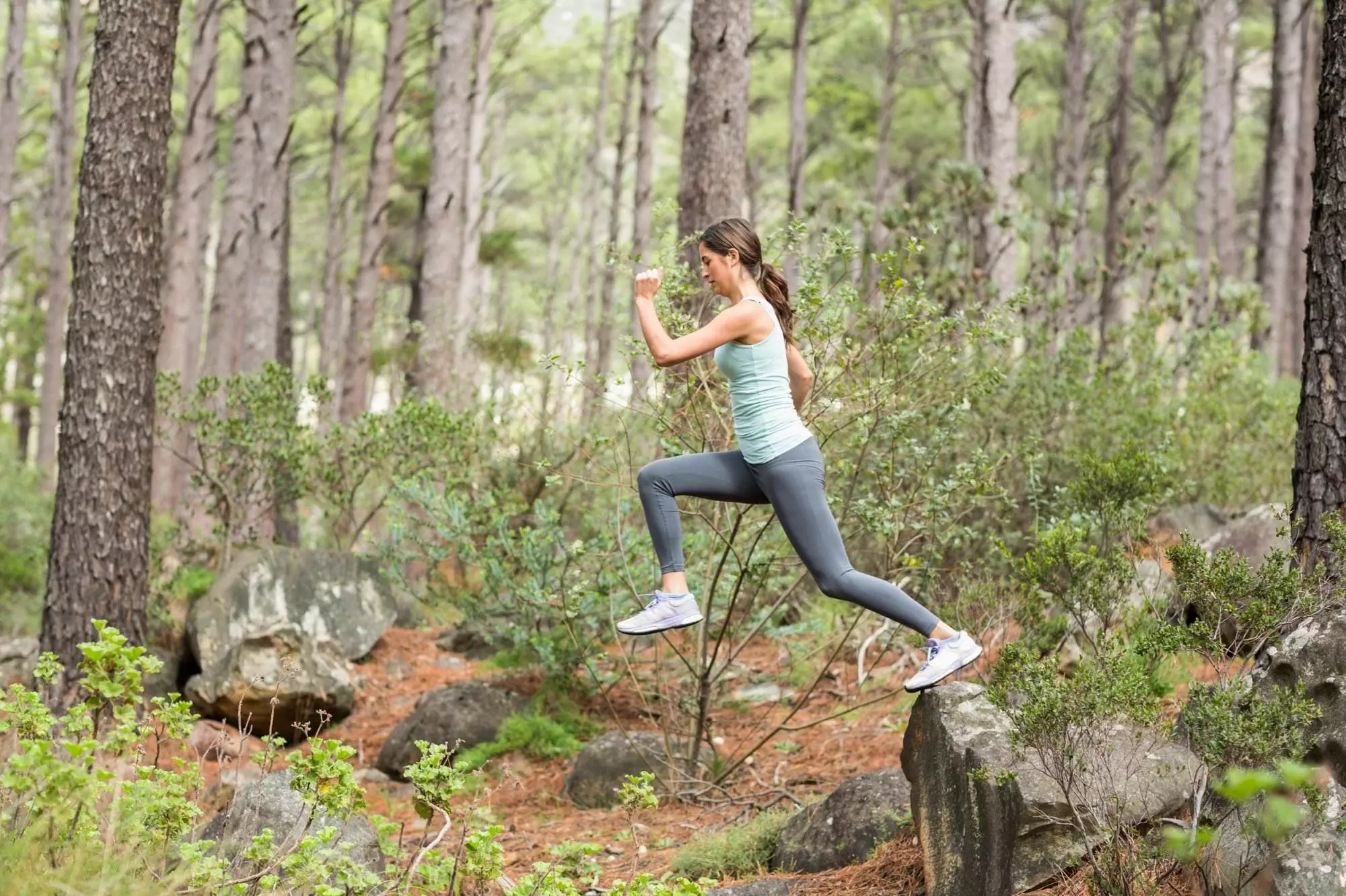 Woman running in a forest trail