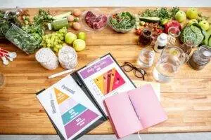Healthy meal planning with nutrition charts and fresh foods