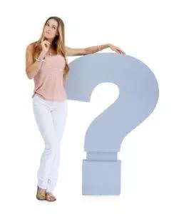 Woman leaning on large question mark, pensive expression.
