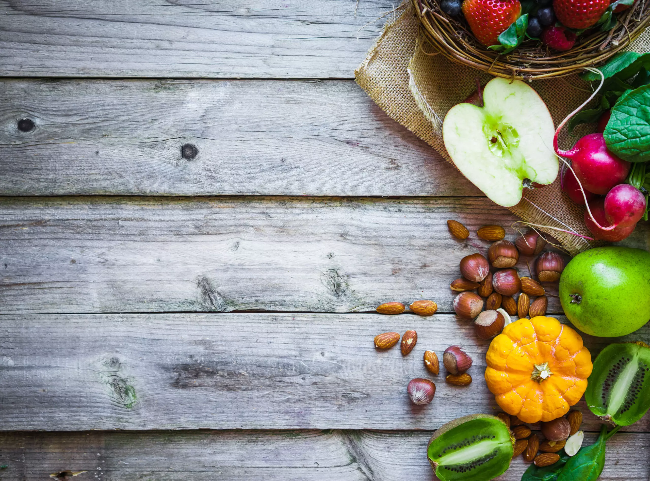 Fresh fruits and nuts on wooden background